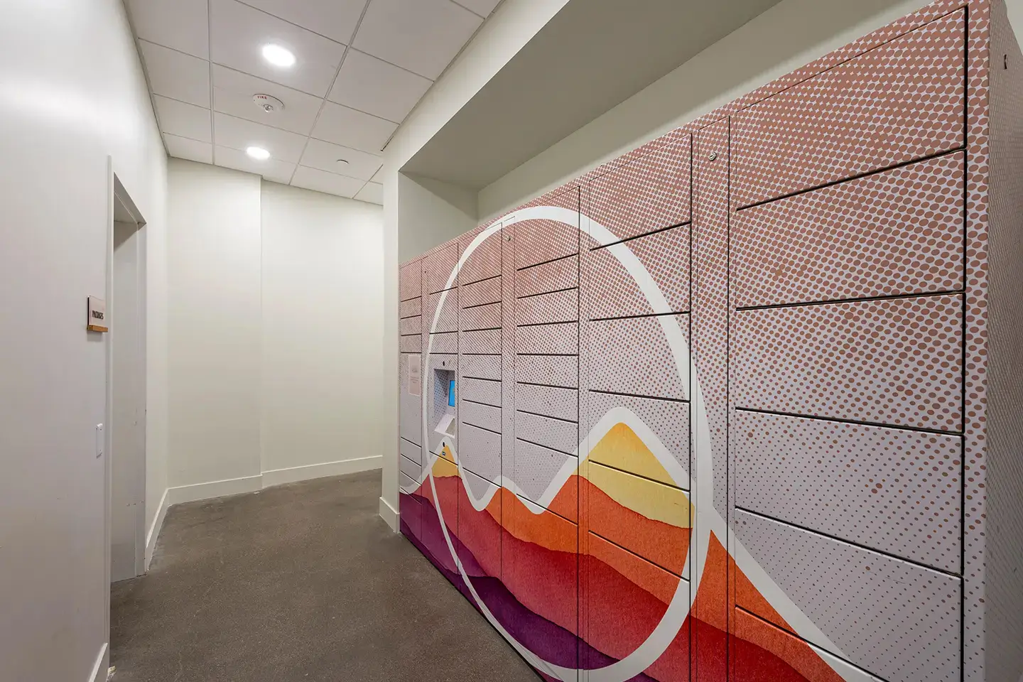 Apartment complex package locker with a colorful mountain painted on top