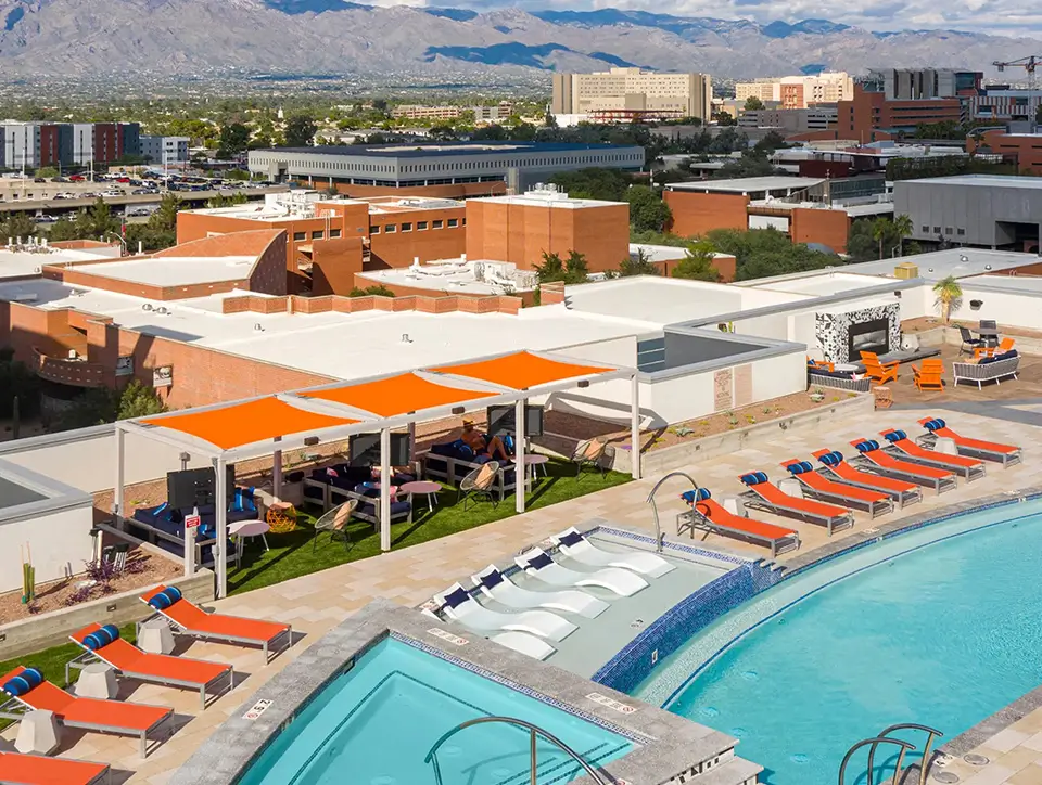 Pool deck with orange cabanas and mountain views